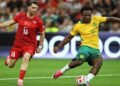 Australia's Nestory Irankunda (17) scores the first goal of the match in front of Turkey's Ismail Yuksek (16) during the World Cup Group D soccer match between Australia and Turkey in Vancouver, Canada, Saturday, June 13, 2026. (AP Photo/Kaleb Tatum)
