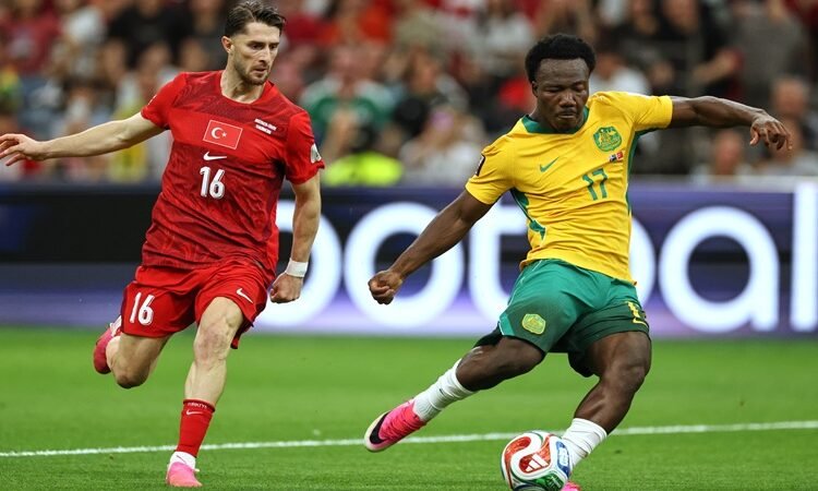 Australia's Nestory Irankunda (17) scores the first goal of the match in front of Turkey's Ismail Yuksek (16) during the World Cup Group D soccer match between Australia and Turkey in Vancouver, Canada, Saturday, June 13, 2026. (AP Photo/Kaleb Tatum)