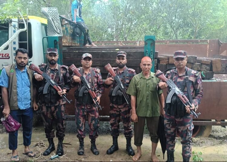 Truck carrying smuggled 'Goda' timber seized in Bandarban; novel smuggling method uncovered.